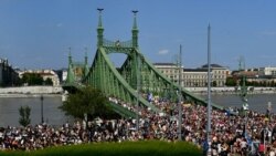 People march across the Szabadsag, or Freedom Bridge, over the River Danube during a gay pride parade in Budapest, Hungary, July 24, 2021.