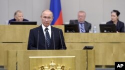 FILE - Russian President Vladimir Putin, foreground, speaks to Russia's lower house of parliament in Moscow, Oct. 5, 2016. 