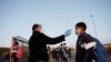 FILE - A student is screened as schools begin to reopen after the coronavirus disease lockdown in Langa township in Cape Town, South Africa, June 8, 2020.
