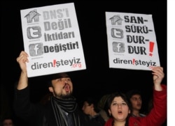 FILE - People hold placards that read "stop censorship" during a rally against proposed government curbs on access to some websites in Ankara, Turkey, Jan. 18, 2014.