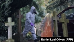 Emergency personnel wearing protective suits work at the London Road Cemetery in Salisbury, where the wife and son of former double agent Sergei Skripal are buried, March 10, 2018.