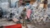 FILE - A soldier walks past wreckage in the aftermath of an attack on the Afrik Hotel in Mogadishu, Somalia, on Feb. 1, 2021. At least five people died in the attack by al-Shabab militants.