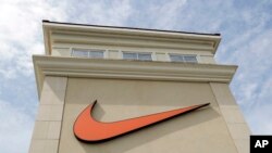 FILE - A Nike logo is displayed outside a Nike store in Charlotte, N.C., Sept. 4, 2018.