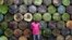 Steel barrel vendor Lassiney Diarra poses for a picture in front of barrels in Bamako, Mali, Aug. 13, 2013.