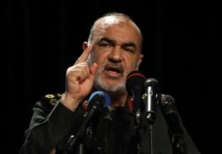 Chief of Iran's Revolutionary Guard Gen. Hossein Salami speaks in a ceremony displaying pieces of the American drone shot down by the Guard in the Strait of Hormuz in June, in Tehran, Iran, Sept. 21, 2019.