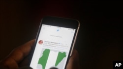 A man used his mobile phone to read headline news on Twitter inside an office in Lagos, Nigeria, June 7, 2021.