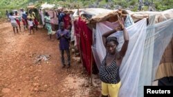 People stay in makeshift tents at a camp after the 7.2 magnitude quake on August 14 damaged or destroyed their houses in the Nan Konsey neighborhood in Pestel, Haiti August 23, 2021. REUTERS/Ricardo Arduengo