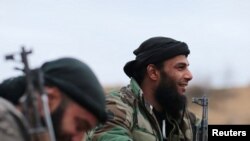 Rebel fighters of Jaysh al-Islam rest with their weapons near the front of the rebel-held Douma neighborhood of Damascus, Syria Jan.2, 2017. 