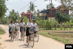 សិស្សានុសិស្សជិះកង់ជុំគ្នាធ្វើដំណើរទៅមករវាងសាលារៀន និងផ្ទះ នៅស្រុកខ្សាច់កណ្តាលជារូបភាពដែលម្តាយរបស់ កញ្ញា ឌុំ រីដា រំលឹកអំពីអតីតកាលនៅពេលដែលកូនស្រីរបស់អ្នកស្រីធ្វើដំណើរទៅសាលារៀន នៅខេត្តកណ្តាល នៅថ្ងៃទី០២ ខែមេសា ឆ្នាំ២០១៩។ (ខាន់ សុគុំមនោ/VOA)