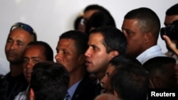 Venezuelan opposition leader Juan Guaido, whom many nations have recognized as the country's rightful interim ruler, sings the national anthem during a meeting regarding the condition of the water and electricity systems in Caracas, Venezuela, March 28, 2