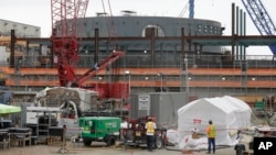 A containment building for unit two of the V.C. Summer Nuclear Station near Jenkinsville, S.C., is shown during a media tour of the facility Sept. 21, 2016. Construction of the nuclear power plant was halted on July 31, 2017 after $9 billion. (AP Photo/Chuck Burton/File photo) 