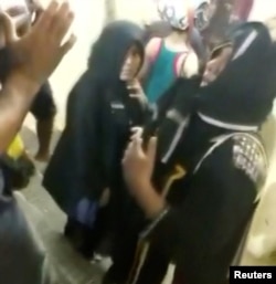 Men talk to two women who entered the Sabarimala Temple in Pathanamthitta, Kerala, India, Jan. 2, 2019. (Kerala Police/Handout)