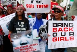 FILE - Women attend a demonstration calling on government to rescue kidnapped school girls of a government secondary school Chibok, in Lagos, Nigeria, May. 5, 2014.