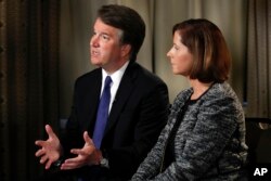 FILE - Brett Kavanaugh, with his wife Ashley Estes Kavanaugh, answers questions during a FOX News interview in Washington, Sept. 24, 2018, about allegations of sexual misconduct against the Supreme Court nominee.
