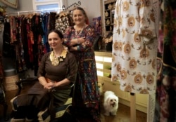 Erika and Helena Varga pose for photographs in their fashion studio, Romani Design, in Budapest, Hungary, Dec. 12, 2021.