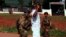 French soldiers run a check on a civilian along a street in Central African Republic's capital Bangui, Dec. 23, 2013. 