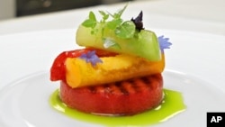 This June 19, 2006 file photo shows an appetizer of grilled watermelon topped with tomatoes, basil and aged balsamic vinegar at Eleven Madison Park in New York. The restaurant announced it will no longer serve meat. (AP Photo/Richard Drew, File)