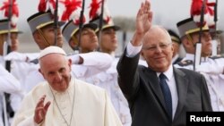 Pope Francis and Peru's President Pedro Pablo Kuczynski wave, in Lima, Peru, Jan. 18, 2018.