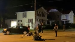 USA, Visconsin, Kenosha, A man is being shot in his arm during a protest following the police shooting of Jacob Blake