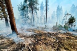 FILE - The Bootleg Fire is seen smoldering in southern Oregon, July 17, 2021, in this photo provided by the Bootleg Fire Incident Command.