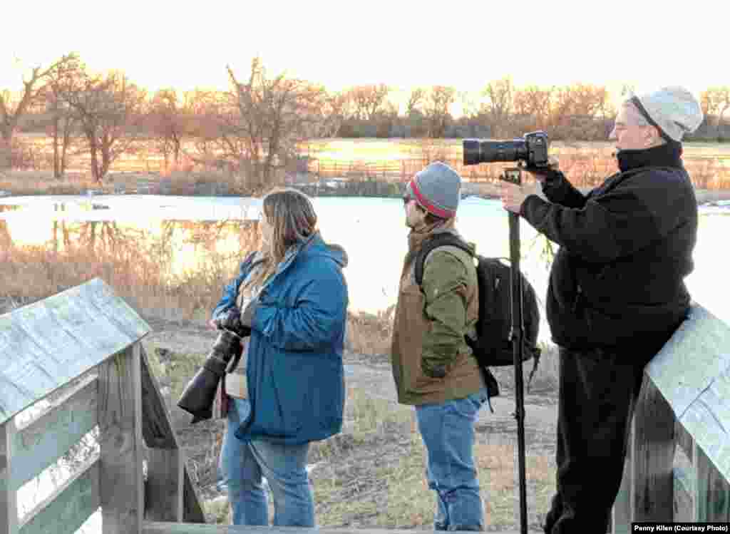 Photographers from all over the world capture the colorful cranes from blinds or these river-side platforms, near Gibbon, Nebraska, March 16, 2019.