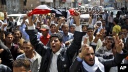 Yemeni anti-government demonstrators chant slogans during a demonstration celebrating the resignation of Egyptian leader Hosni Mubarak and demanding the ouster of their own president, in Sanaa, Yemen, Feb 12, 2011