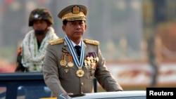Myanmar's General Min Aung Hlaing, right, takes part in a parade to mark the 72nd Armed Forces Day in the capital, Naypyitaw, Myanmar, March 27, 2017. 