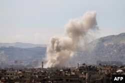 Smoke billows following a reported air strike in the rebel-held parts of the Jobar district, on the eastern outskirts of the Syrian capital Damascus, March 19, 2017.
