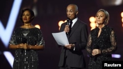Wham band members Andrew Ridgeley, Pepsi and Shirley pay tribute to George Michael at the Brit Awards at the O2 Arena in London, Feb. 22, 2017.
