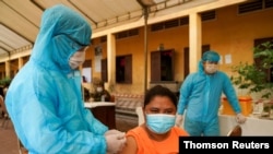 FILE PHOTO: Cambodian army members vaccinate people in Phnom Penh