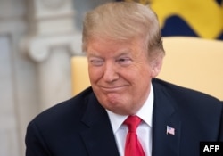 FILE - U.S. President Donald Trump winks during a meeting with Israeli Prime Minister Benjamin Netanyahu in the Oval Office at the White House in Washington, March 25, 2019.