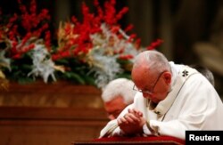 Pope Francis leads the Christmas Eve Mass in Saint Peter's Basilica at the Vatican, Dec. 24, 2017.