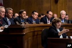 Phoenix prosecutor Rachel Mitchell questions Christine Blasey Ford as Senators, from left, Sen. Mike Crapo, R-Idaho, Sen. Jeff Flake, R-Ariz., Sen. Ben Sasse, R-Neb., Sen. Ted Cruz, R-Texas, Sen. Mike Lee, R-Utah., and Sen. John Cornyn, R-Texas, listen during the Senate Judiciary Committee hearing, Sept. 27, 2018.