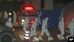 Medical staff arrive at Fukushima Medical University Hospital to treat radiation exposed workers from Tokyo Electric Power Co.'s Fukushima Daiichi Nuclear Power Plant, Fukushima City, Japan, March 24, 2011.