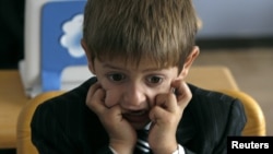 A first grader attends his first English language lesson at a local school in Tbilisi, September 15, 2010.