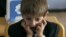 A first grader attends his first English language lesson at a local school in Tbilisi, September 15, 2010.