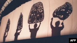 FILE - Members of the Cambodia National Theatre perform the ancient art of shadow puppetry in Phnom Penh on September 27.