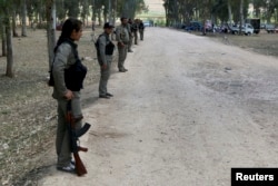 FILE - Kurdish Democratic Union Party (PYD) members stand guard during a Labour Day celebration in Efrin. The U.S. is urging both Turkey and the YPG/PYD to show restraint.
