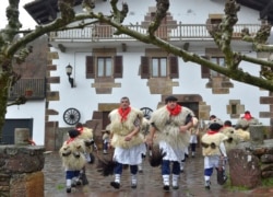 FILE - Bellringers, known as "Joaldunak" in Basque language march with big cowbells hanging on their back during the ancient carnival of Ituren, in the northern Spanish Navarra province, Jan. 28, 2019.