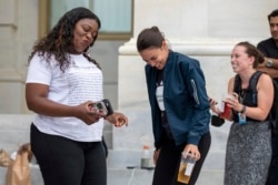 Rep. Cori Bush, D-Mo., and Rep. Alexandria Ocasio-Cortez, D-N.Y., have an impromptu dance party to "Run the World (Girls)" by Beyonce after it was announced that the Biden administration will enact a targeted nationwide eviction moratorium outside of Capitol.
