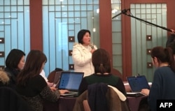 North Korean defector Kim Ryon-Hui (C) speaks to reporters during a press conference by Tomas Ojea Quintana, the UN's Special Rapporteur on human rights in North Korea, in Seoul on Dec, 14, 2017.