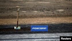 A shovel and FoxConn logo are seen before the arrival of U.S. President Donald Trump as he participates in the Foxconn Technology Group groundbreaking ceremony in Mount Pleasant, Wisconsin, June 28, 2018.