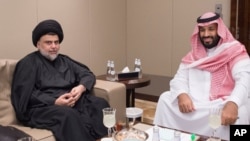 Shiite cleric Muqtada al-Sadr, left, meets with Saudi Crown Prince Mohammed bin Salman in Jiddah, Saudi Arabia, July 30, 2017.