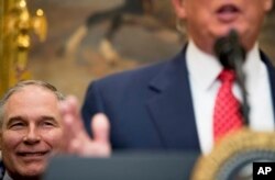 FILE - EPA administrator Scott Pruitt listens as President Donald Trump speaks before signing the Waters of the United States executive order, Feb. 28, 2017, in the Roosevelt Room of the White House.