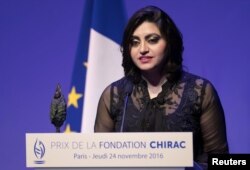 FILE - Pakistan's Gulalai Ismail delivers an acceptance speech after being awarded the Prize for Conflict Prevention for the work of her organization "Aware Girls" promoting women's issues and equality in Pakistan, during the award ceremony of the Jacques Chirac Foundation at the Musee Branly in Paris, France, Nov. 24, 2016.
