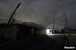 A house is lit with a generator, on a street in Naguabo, Jan. 25, 2018.