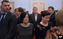 FILE - Jehovah's Witnesses react in a courtroom after a judge's decision in Moscow, April 20, 2017, to ban the group. On Monday Russia's Supreme Court, ruling on an appeal, upheld the ban.