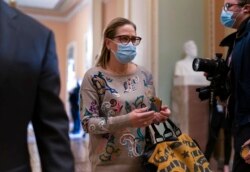 Sen. Kyrsten Sinema, D-Ariz., walks to the chamber after a Senate Democratic Caucus meeting at the Capitol in Washington, Nov. 2, 2021.