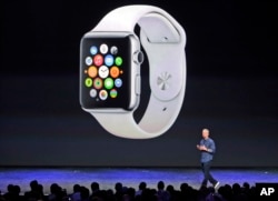 FILE - Apple CEO Tim Cook introduces the new Apple Watch on Tuesday, Sept. 9, 2014, in Cupertino, Calif. Apple's new wearable device marks the company's first major entry in a new product category since the iPad's debut in 2010. (AP Photo/Marcio Jose Sanchez)