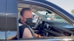 Arnold Schwarzenegger looks on after receiving a coronavirus disease